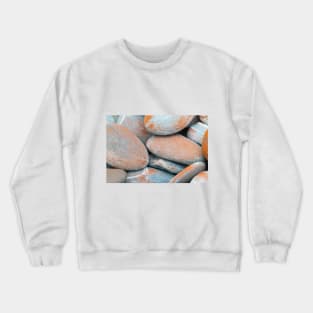 Beach stones in grey with orange coloured lichen growth Crewneck Sweatshirt